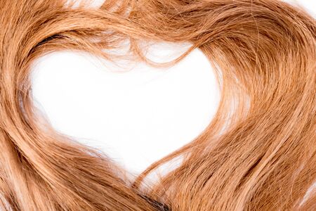 shiny and clean red hair on white background with hear shapeの写真素材