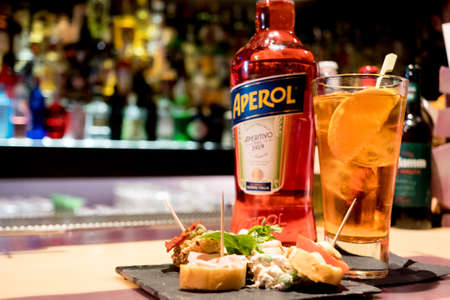 Milan, Italy - 20 april 2019: bottle of italian drink aperol spritz on bar top with traditional italian happy hour aperitivoのeditorial素材