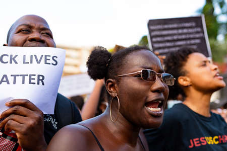 Barcelona, spain - 1 june 2020: Black lives matter woman march demanding end of police brutality and racism against african-americans chanting and screamingのeditorial素材