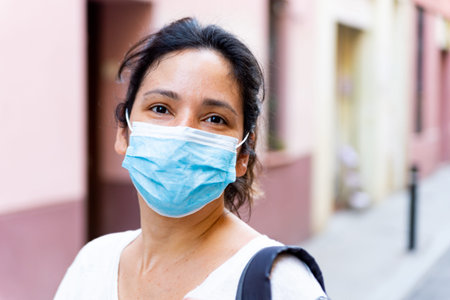 young tourist wearing face mask sightseing in european city. traveling and tourism industry during...