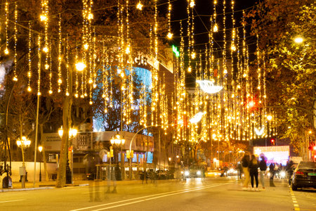 barcelona, spain - 21 december 2020: christmas shopping time in barcelona passeig de gracia street. crowd at night doing christmas shopping with christmas lights before curfewのeditorial素材