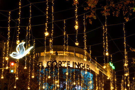 barcelona, spain - 21 december 2020: christmas time in barcelona plaza de catalunya at night with el corte ingles mall with christmas lights before night curfew imposed for covid19のeditorial素材