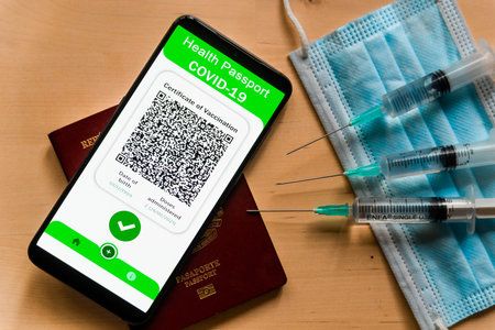 A Covid certificate, also called covid vaccine pass, is seen on the screen of a mobile phone with...