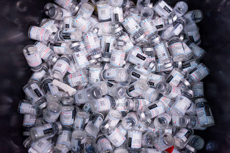 Empty vials of Moderna vaccines are seen in a trash bin at a vaccination center in Barcelona, Spain on December 22, 2021. As countries push for mass vaccinationのeditorial素材