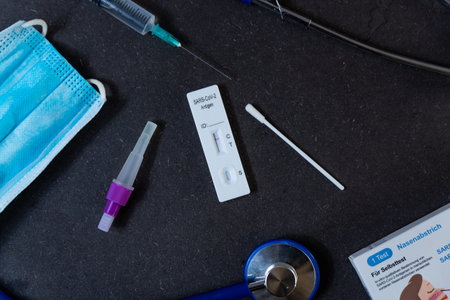 A rapid antigen test for SARS-CoV-2 or Covid is seen on a table with nasal swab stick during a rapid...