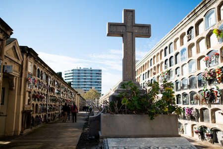 View of Poble Nou cemetery on a sunny day with historical statues and graves, with crosses and christian symbols and flowers. concept of death in Barcelona, Spain - 1 November 2021のeditorial素材