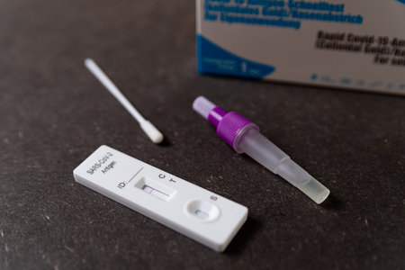 A rapid antigen test for SARS-CoV-2 or Covid is seen on a table with nasal swab stick during a rapid...