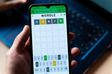 A man plays with the word game Wordle seen in a close up on a mobile phone screen on the official app website in Barcelona, Spain - 9 February 2022.のeditorial素材