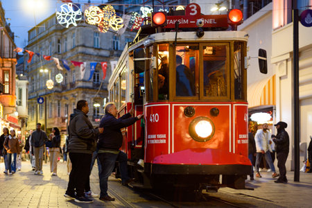 Istanbul, Turkey - 20 April 2023: people are seen boarding a traditional tram in Istiklal Street in the city center at night. Public transport in Istanbulのeditorial素材