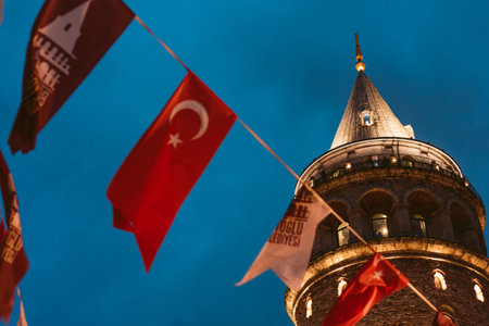 Istanbul, Turkey - 20 April 2023: The Galata tower in the Old Town is seen at night with Turkish...