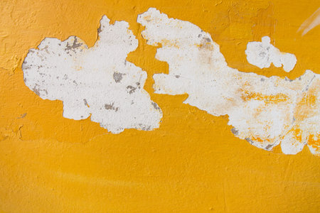 Old cracked yellow wall background