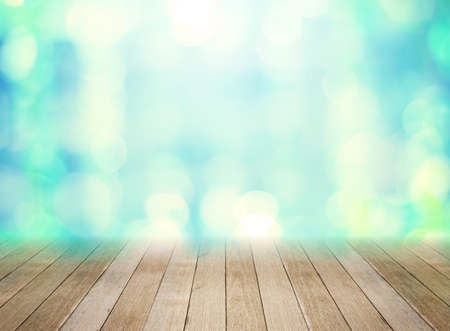 Wooden board in front of blurred green backgroundの写真素材