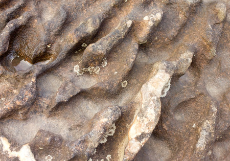 The weathering of the rock caused by erosion of water