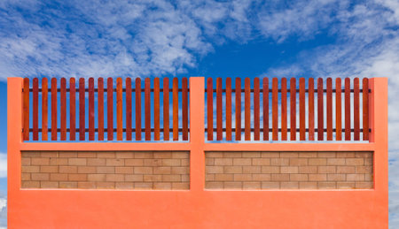 Orange fence and blue sky の写真素材