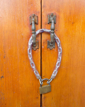 wooden doors are locked with a keyの写真素材