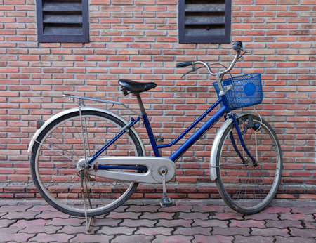 the old bicycle against a brick wallの写真素材