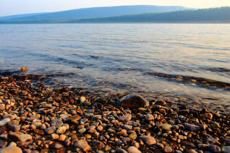 rocky river Bank at sunset in summer in Yakutiaの写真素材