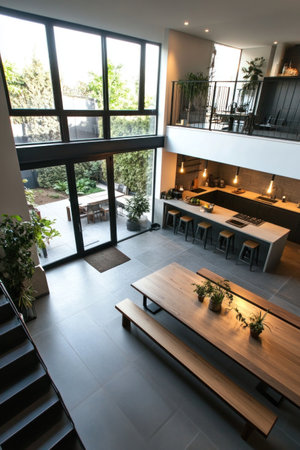 A modern house with an open floor plan, the kitchen and dining area on one side of the room. Large windows overlook the outside in an urban setting. There is a bench at each end of the long table, and stairs leading up from the living space. The flooring is a grey tile, suitable for indoor plant decorations. --ar 2:3 --v 6.1 Job ID: b3c2169c-e1d7-4295-acef-702ea62488b8の素材