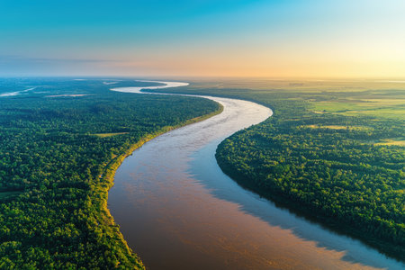A wide river with brown water flowing through green fields, seen from above. The sky is blue, and the trees on both sides of the bank create an endless horizon. A drone captures the scene in high resolution, providing detailed and immersive footage for documentary or nature-inspired projects. --chaos 30 --ar 3:2 --quality 2 --stylize 250 --v 6.1 Job ID: b58acbf7-0c00-442e-9d11-422dbad365e3の素材