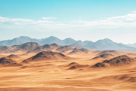 The image showcases a wide desert landscape with mountains, dunes, and an expansive blue sky.の素材