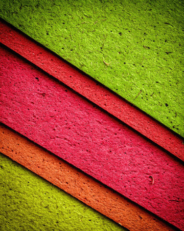 Close-up view of a textured surface composed of multiple layers of vibrant colors arranged in diagonal stripes.  The surface has a slightly rough or granular appearance.の素材