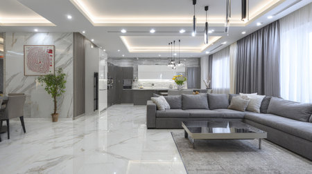 Modern living room featuring a large gray sectional sofa, marble flooring, and open-concept design.  The room is well-lit and spacious, with large windows and stylish neutral color tones.  It includes a dining area with a gray table and chairs.の素材