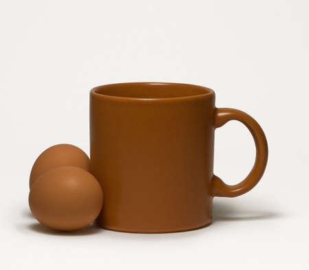 Still-life with a brown mug on whiteの写真素材