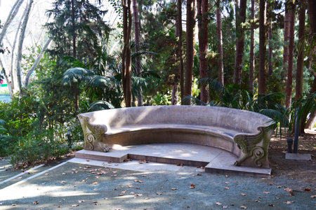 Exedra "meeting area with seating" from the 19th century. Bench with animal legs common in landscape-style gardens. Botanical Garden of Malaga, Andalusia, Spain.のeditorial素材