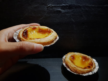 Catching a belem cake on black backgroundの写真素材