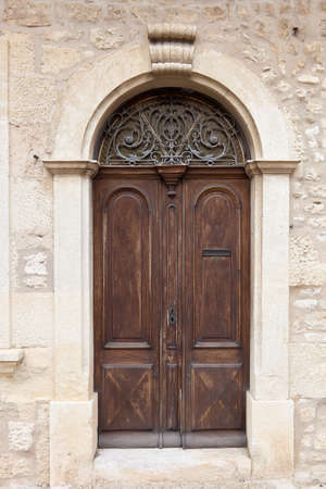 Brown aged rounded door of a an old mansion, Franceの写真素材