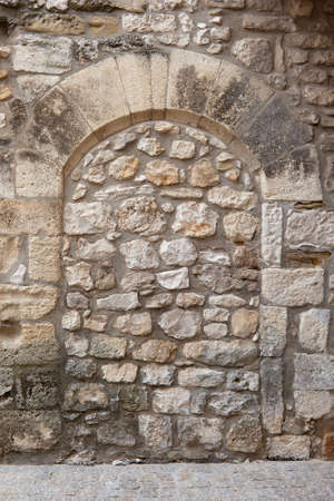 Ancient arch built of block stones, sealed, closed up with irregular natural stones  France, Provenceの写真素材