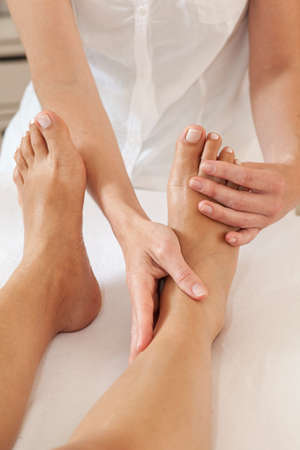 Professional feet massage - female massager and female feetの写真素材