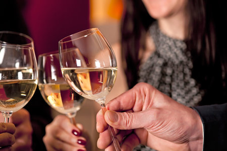 Having a good time and partying with a glass of wine.