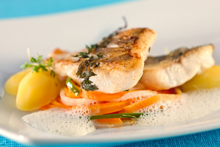 White fish filet of perch in white sauce.