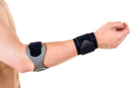 Close Up of Man Wearing Orthopedic Wrist and Elbow Braces in Studio with White Background and Copy Spaceの写真素材