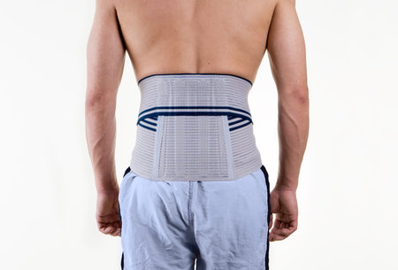 Rear View Close Up of Unrecognizable Shirtless Man in Studio with White Background Wearing...