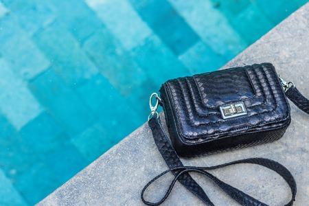 Bags fashion trends. Close up of gorgeous stylish snakeskin python bag. Luxury handbag closeup.の写真素材