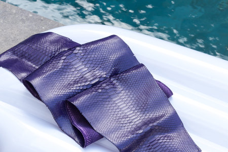 Genuine python snakeskin leather, snake skin, texture background. Swimming pool on a background.