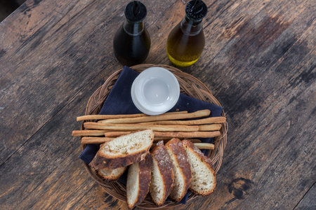 Freshly baked sliced bread on rustic wooden table, close up of brown bread.