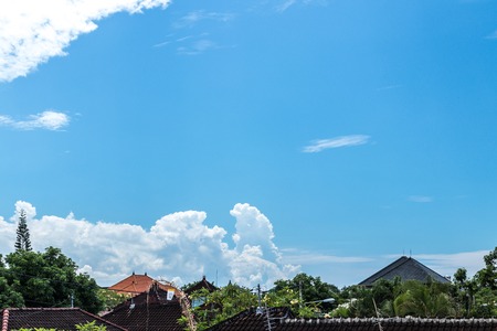 Blue sky with clouds, balinese landscape, tropical Bali island, Indonesia. Balinese houses.の写真素材