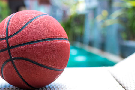 Basketball ball on a swimming pool background, tropical sport scene.の写真素材