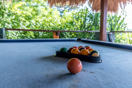 Billiard balls in a blue pool table, game. Outside, tropical cafe, Bali island.の写真素材