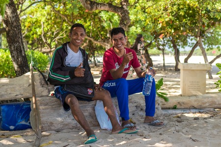 BALI, INDONESIA - APRIL 23, 2017: Indonesian fishermen guys on the Nusa Dua beach, tropical Bali island, Indonesia.のeditorial素材