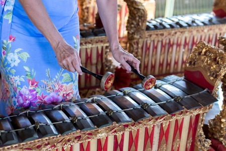Woman hands and Traditional Balinese music instrument gamelan. Bali island, Indonesia.の写真素材