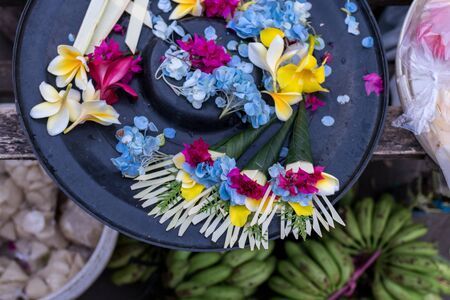 Offerings to gods in Bali with flowers. Exotic tropical Bali island, Indonesia.の写真素材