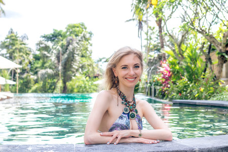 Sexy Beautiful woman sunbathing in swimming pool. Luxury model at the pool.
