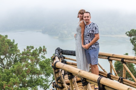 Attractive young loving romantic couple on the tropical fog landscape of Bali island, Indonesia.の写真素材