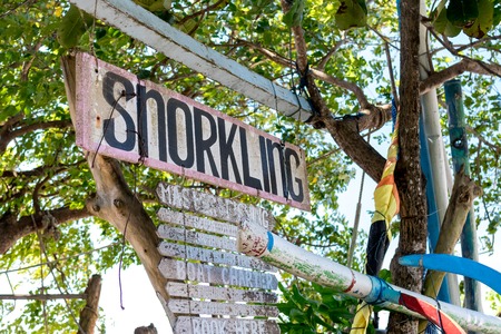 Wooden plate with text snorkling on the Sanur beach, tropical island Bali, Indonesia.の写真素材