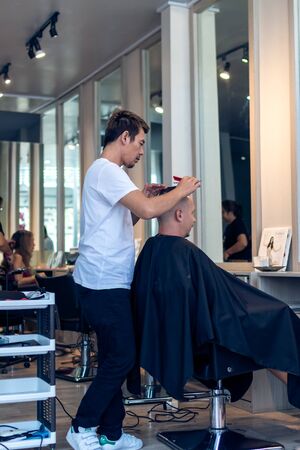 BALI, INDONESIA - JUNE 2, 2017: Hair stylist at barber shop on Bali island. Indonesiaのeditorial素材