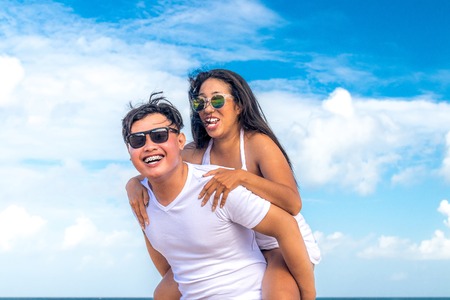 Asian couple having fun on the beach of tropical Bali island, Indonesia.の写真素材